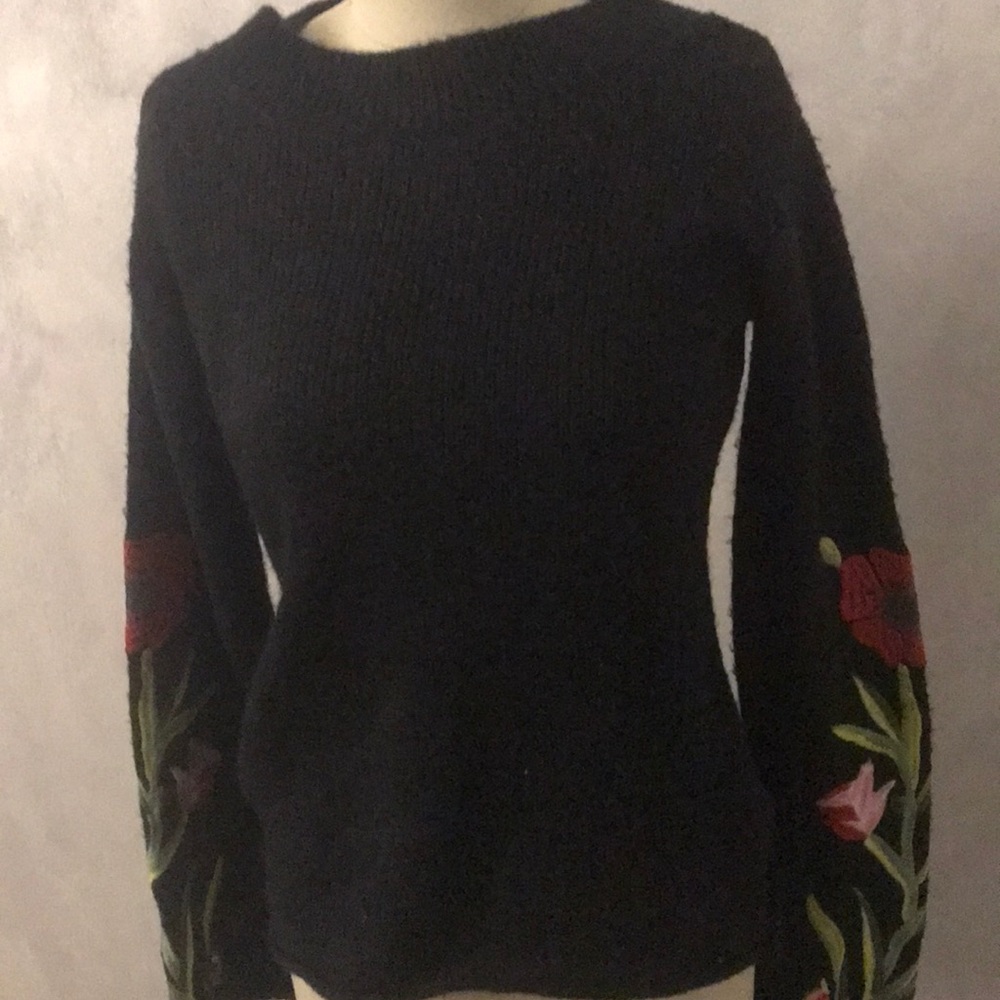 Black sweater with floral embroidery.